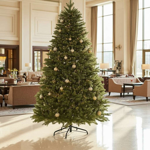 A large, premium Christmas tree with gold ornaments displayed in an elegant hotel or business lobby.