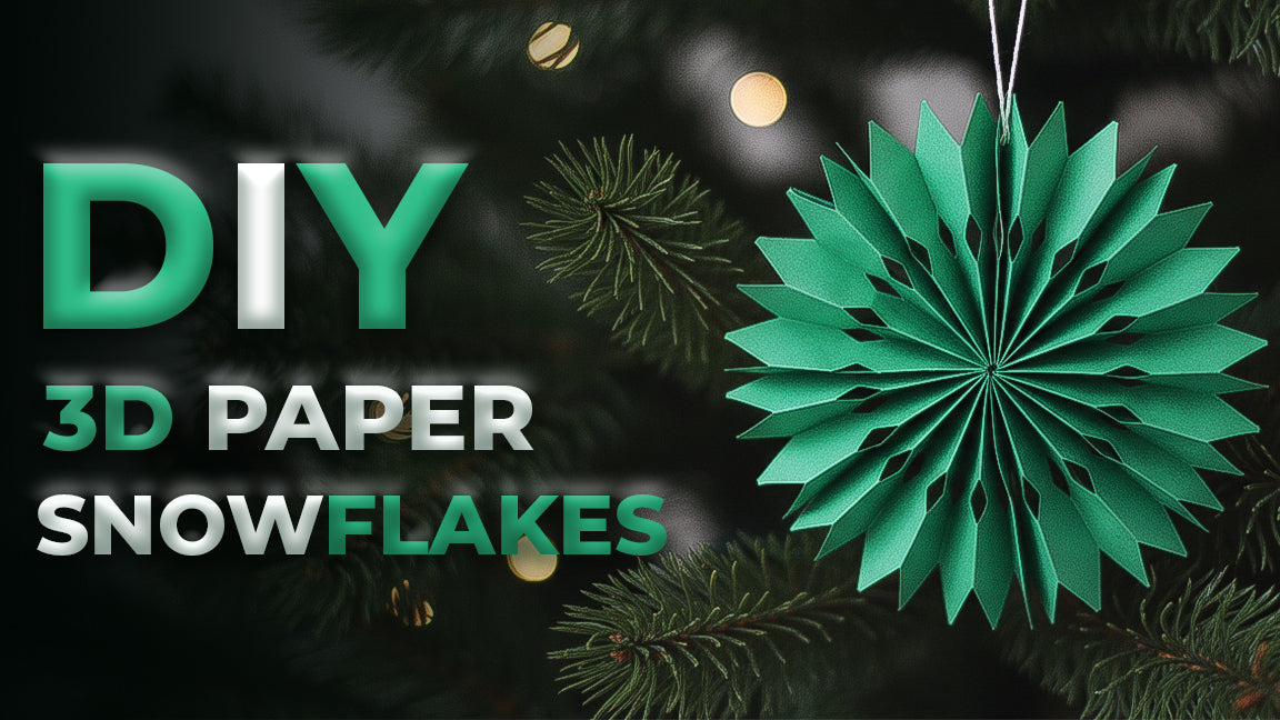 A green 3D paper snowflake ornament hanging on a Christmas tree for a DIY holiday craft tutorial.