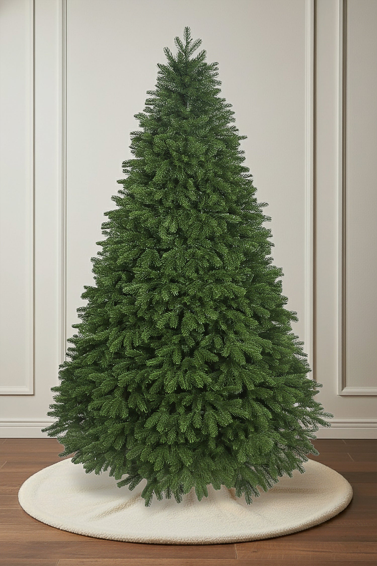 A full view of the unlit Verdelle Fir Christmas tree, featuring a classic cone shape and dense, lush foliage.