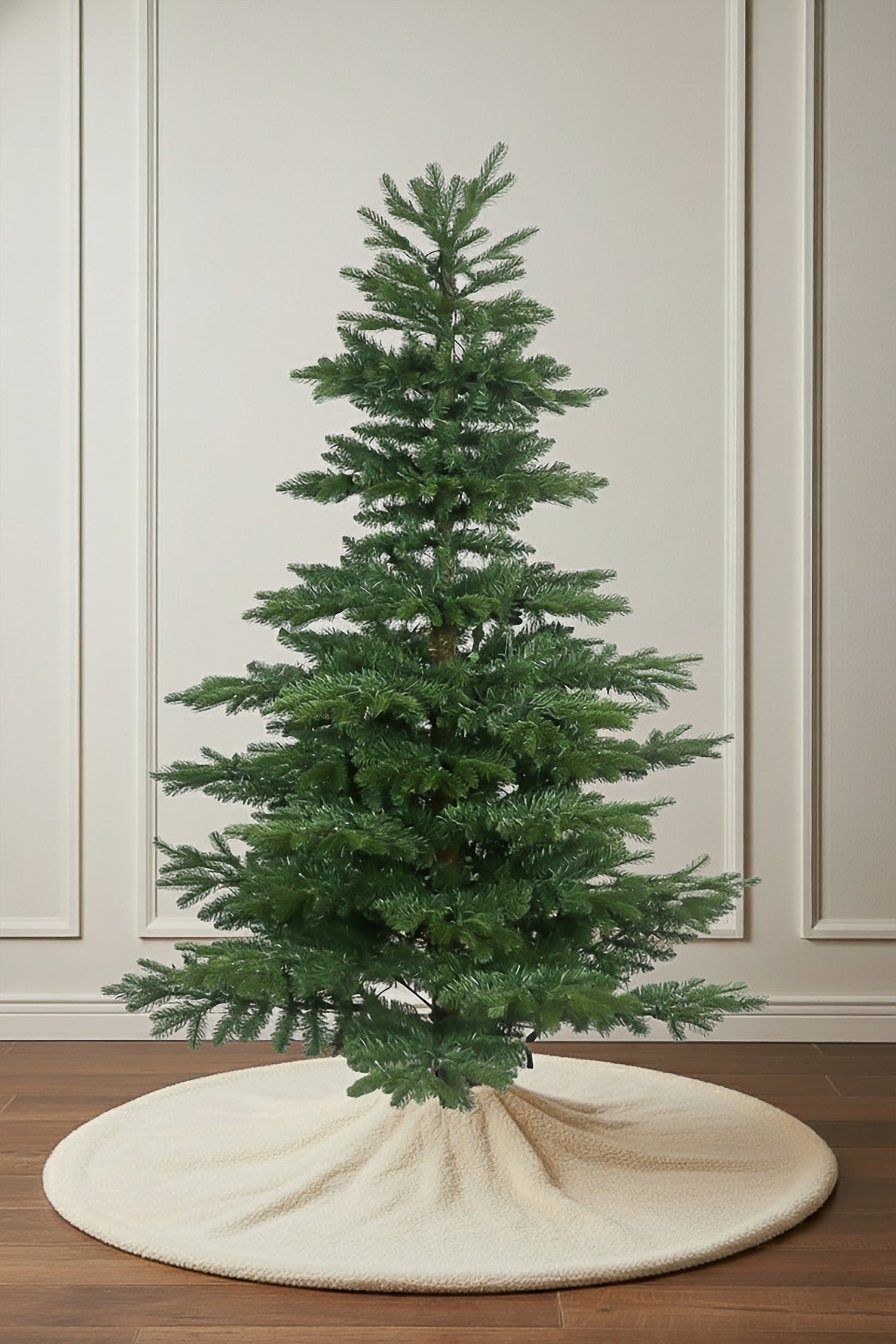 A studio photo of the unlit Noble Fir Christmas tree, highlighting its distinct, layered branches and realistic look.