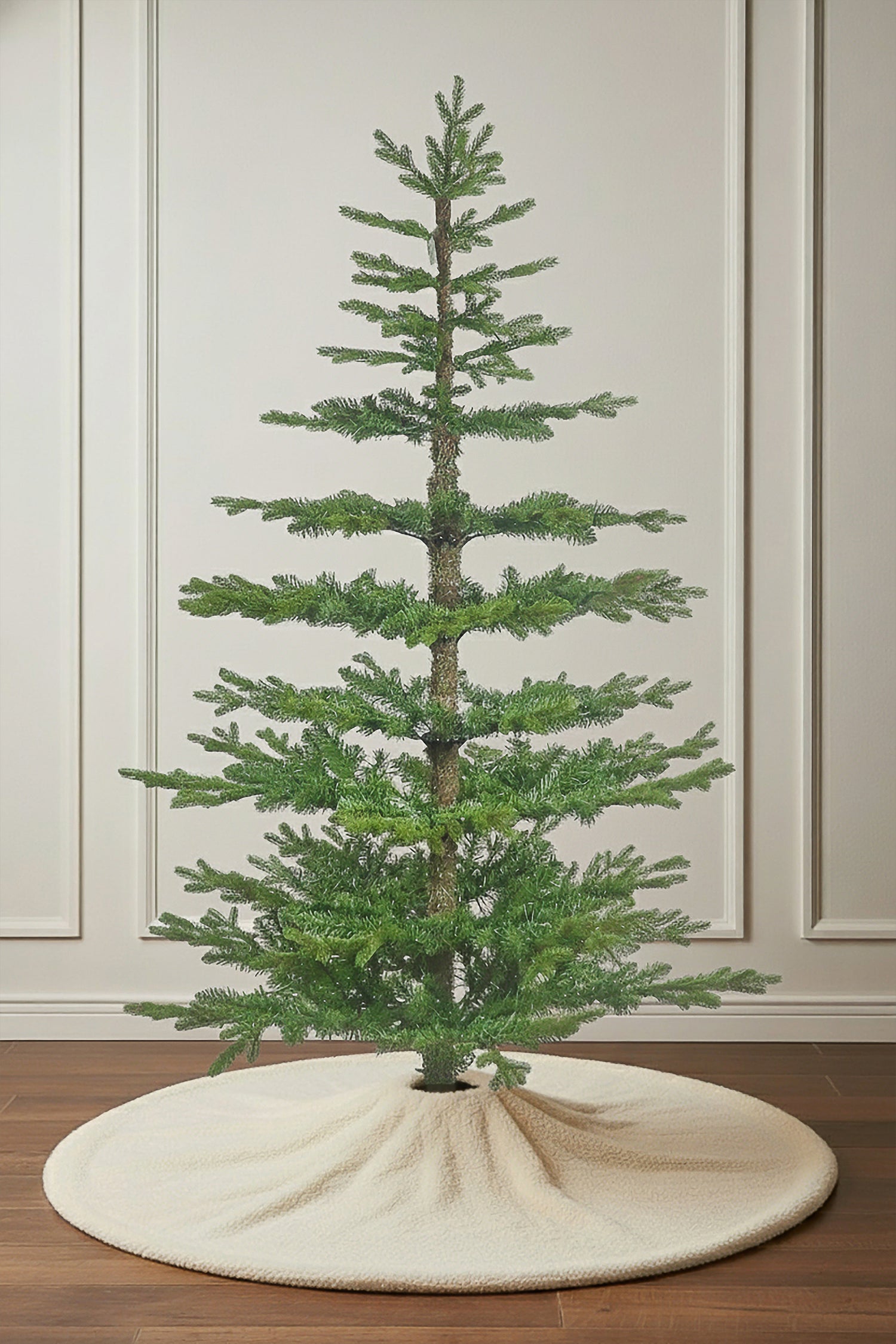 The pre-lit Skinny Winterglade Fir Christmas tree, showing its sparse, modern design and warm lights.