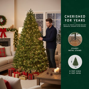 Man with 9 ft prelit classic Christmas tree, with a graphic showing its sturdy metal stand and 6 ft width.