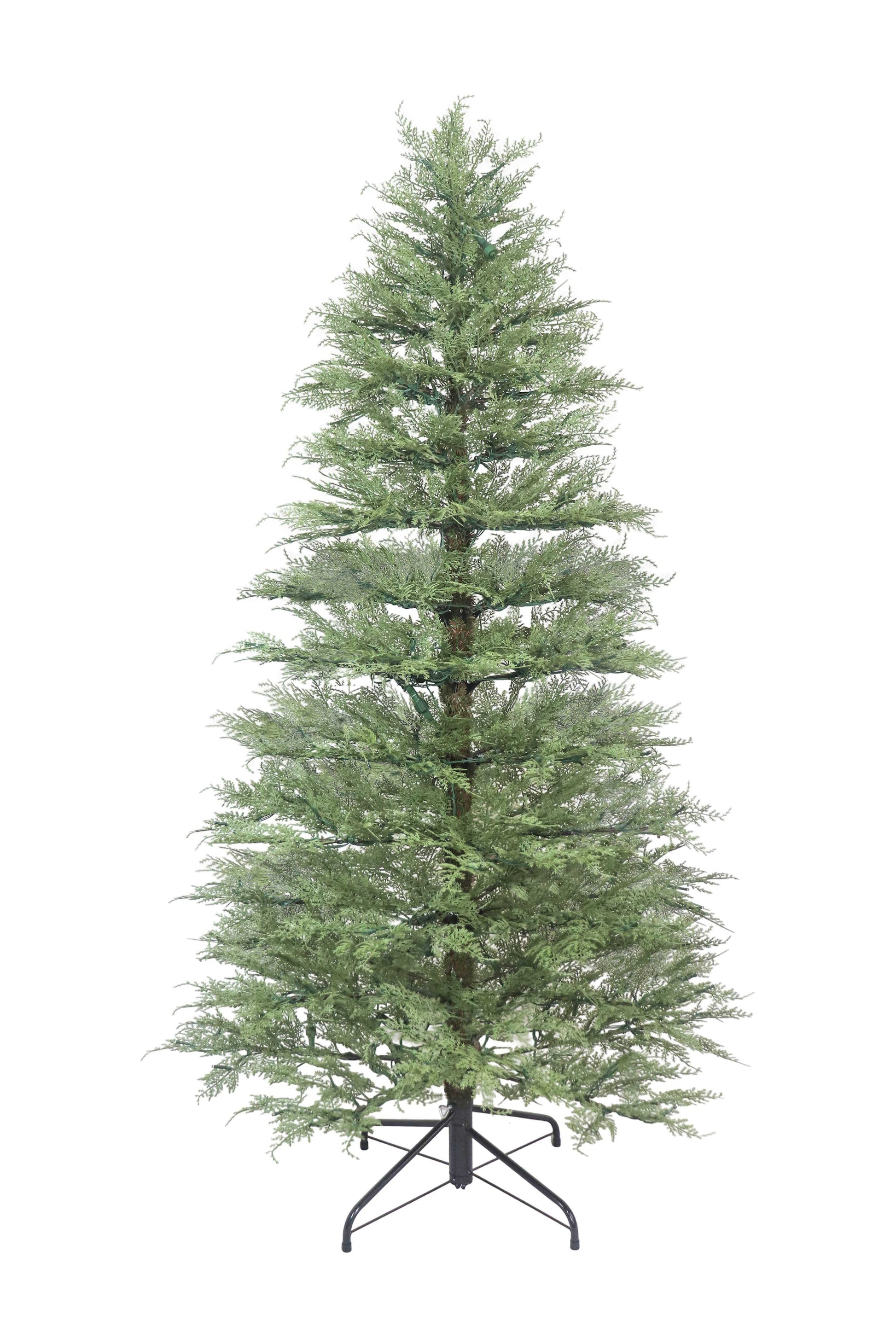 An unlit minimalist artificial cypress Christmas tree standing on its metal base against a white background.