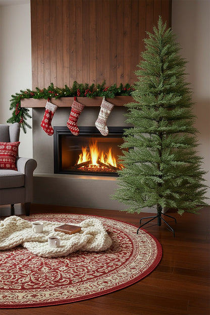 An unlit, minimalist cypress Christmas tree standing next to a cozy fireplace with holiday stockings.